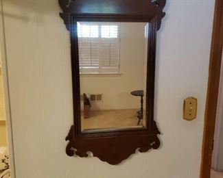 Beveled mirror with walnut carved frame