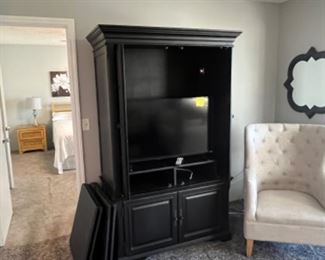 Black Armoire/entertainment unit with a Vizio TV inside