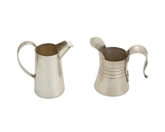 1006
Two William Spratling Sterling Silver Cream Jugs
William Spratling (1900-1967)
Circa 1951-1967, Third Design Period; Taxco, Mexico
Each stamped for William Spratling and sterling; Further stamped: [Eagle 30]
Two sterling silver creamers, both with pronounced spout and handle, shorter creamer with applied disc motif under handle, 2 pieces

Largest creamer: 3.25" H x 3" W; smallest creamer: 2.875" H x 3" W
4.070 oz. troy approximately
Estimate: $300 - $500