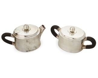 1008
A William Spratling Sterling Silver Cream And Sugar Set
William Spratling (1900-1967)
Circa 1951-1967, Third Design Period; Taxco, Mexico
Each stamped for William Spratling; Further stamped: [Eagle 30]
A hinged creamer and lidded sugar each with rosewood handles, 2 pieces

Creamer: 3.25" H x 5.5" W; sugar: 3" H x 6" W
11.390 gross oz. troy approximately
Estimate: $400 - $600