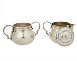 1009
A William Spratling Sterling Silver Creamer And Sugar
William Spratling (1900-1967)
Circa 1931-1946, First Design Period; Taxco, Mexico
Each stamped for William Spratling and sterling
A lidded, two handled sugar bowl with ball finial and a creamer, 2 pieces

Sugar: 3.25" H x 5" W x 2.5" Dia.; creamer: 3.5" H x 4" W x 2.25" Dia.
7.970 oz. troy approximately
Estimate: $200 - $300