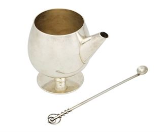 1017
A William Spratling Sterling Silver Martini Pitcher And Spoon
William Spratling (1900-1967)
Circa 1951-1967, Third Design Period; Taxco, Mexico
Each stamped for William Spratling; Further stamped: [Eagle 30]
A cocktail shaker/mixer, goblet-shaped on a short stem, together with a spoon with ball and loop decoration, 2 pieces

Pitcher: 5.125" H x 3.25" Dia.; spoon: 8.75" L
14.940 oz. troy approximately
Estimate: $500 - $700