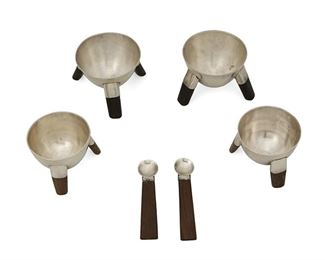 1037
A Group Of William Spratling Sterling Silver Salt Cellars
William Spratling (1900-1967)
Circa 1964-1967, Third Design Period; Taxco, Mexico
Each stamped for William Spratling and sterling; Salt dishes further stamped: [Eagle 30]
Comprising four small silver salt dishes, two with ebony legs and two with rosewood legs, together with two rosewood handled salt spoons, 6 pieces

Salt dishes: 1.5" H x 1.875" Dia.; Spoon: 2.625" L
4.600 gross oz. troy approximately
Estimate: $400 - $600