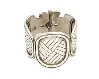 1051
A William Spratling Silver Link Bracelet
William Spratling (1900-1967)
Circa 1942, First Design Period; Taxco, Mexico
Stamped: Spratling Silver / Made in Mexico
A large, hinged link sterling bracelet with three graduated oval petate weave design panels and a pin closure

7" inner C x 2.375" H
149.3 grams
Estimate: $1,800 - $2,250
