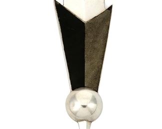 1066
A William Spratling Arrow Brooch
William Spratling (1900-1967)
Circa 1951, Third Design Period; Taxco, Mexico
Stamped for William Spratling; Further stamped: Spratling of Mexico / [Eagle 1]
A stylized silver two-tone arrow pin set with onyx and obsidian inlay

4.25" H x 1.5" W
34.9 grams gross
Estimate: $600 - $900