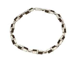 1074
A William Spratling Sterling Silver And Rosewood Necklace
William Spratling (1900-1967)
Circa 1964-1967, Third Design Period; Taxco, Mexico
Partially stamped for William Spratling; Further partially stamped: .925 / [Eagle 30]
A collar chain necklace with twelve checkered rosewood and silver banded wire links

17" L x 0.375" H
47.8 grams gross
Estimate: $800 - $1,200