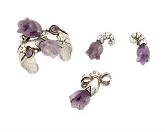 1080
A Mixed Set Of William Spratling Silver And Amethyst Jewelry
William Spratling (1900-1967)
Circa 1940-1946, First Design Period; Taxco, Mexico
Each stamped for William Spratling; Further stamped: Spratling / Silver
Comprising a cuff bracelet designed with silver hands holding carved amethyst flowers (6.25" total inner C x 2.5" H, including a 1.125" opening), a silver brooch of similar design (2.5" H), and a pair of floral earrings (each 1.5" H), 4 pieces

153.2 grams gross
Estimate: $700 - $900