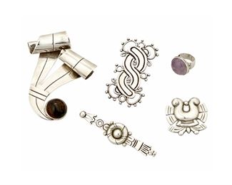 1082
A Group Of William Spratling Silver Jewelry
William Spratling (1900-1967)
Circa 1933-1938 and 1940-1944, First Design Period; Taxco, Mexico
Each stamped for William Spratling; Variously stamped: Taxco / 980 / Made in Mexico / Spratling Silver
Comprised of four sterling brooches in various designs, including a large ribbon brooch with set hardstone (2.75" H x 3" W), as well as a set amethyst ring (Ring size: 3.75), 5 pieces

99.4 grams gross
Estimate: $300 - $500