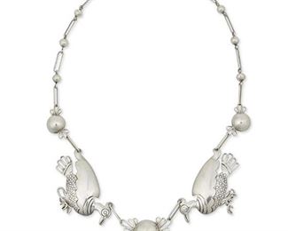 1098
A William Spratling Silver Bird Necklace
William Spratling (1900-1967)
Circa 1939-1940, First Design Period; Taxco, Mexico
Stamped for William Spratling; Further stamped: 980 / Taxco
A link necklace designed as two stylized turkeys suspending three silver bells

20" L x 1.25" H
36.0 grams
Estimate: $1,500 - $2,500