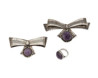 1099
A Group Of William Spratling Silver And Amethyst Jewelry
William Spratling (1900-1967)
Circa 1940-1946, First Design Period; Taxco, Mexico
Each stamped for William Spratling; Further variously stamped: Made in Mexico / Silver / Sterling
A pair of stone set amethyst bow brooches and a set amethyst ring, 3 pieces

Largest brooch: 2.25" H x 4.5" W; Ring: size: 10
128.7 grams gross
Estimate: $500 - $700