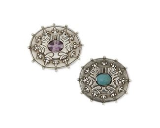 1103
A Pair Of William Spratling Silver And Gem-Set Brooches
William Spratling (1900-1967)
Circa 1933-1939 and 1940-1944, First Design Period; Taxco, Mexico
Each stamped for William Spratling; One stamped: Taxco / 980; One stamped: Made in Mexico / Spratling Silver
Each designed with Aztec motifs, centering one cabochon turquoise and one cabochon amethyst, 2 pieces

Each approximately: 2.125" H x 2.5" W
73.0 grams
Estimate: $600 - $800