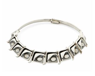 1107
An Antonio Pineda Silver And Moonstone Necklace
Antonio Pineda (1919-2009)
Circa 1953-1979; Taxco, Mexico
Crown mark for Antonio Pineda; Further stamped: [Eagle 208] / Sterling / JCL / Taxco
A sterling collar necklace featuring ten square stylized links each inset with an oval cabochon moonstone

14.5" L x 1" H
141.7 grams gross
Estimate: $3,000 - $5,000
