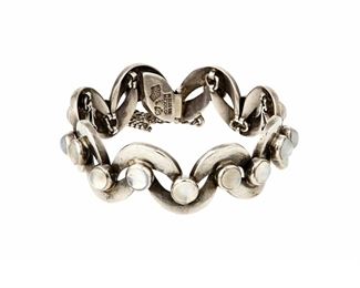 1108
An Antonio Pineda Silver And Moonstone Bracelet
Antonio Pineda (1919-2009)
Circa 1953-1979; Taxco, Mexico
Crown mark for Antonio Pineda; Further stamped: [Eagle 17]/ Hecho en Mexico / 970
Comprising a sterling bracelet with curved links each with set moonstone cabochon

6.5" L x 0.75" H
57.3 grams gross
Estimate: $800 - $1,200