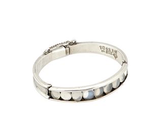 1109
An Antonio Pineda Silver And Moonstone Bangle Bracelet
Antonio Pineda (1919-2009)
Circa 1953-1980; Taxco, Mexico
Crown mark for Antonio Pineda; Further stamped: Hecho en Mexico / 970 / ZZ901 / [Eagle 17]
A hinged sterling bangle bracelet designed with nine floating oval moonstones and a moonstone clasp

6.5" inner C x 0.5" H
47.1 grams gross
Estimate: $500 - $700