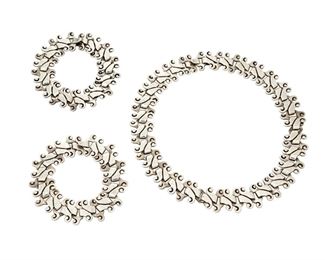 1117
A Suite Of Antonio Pineda Silver Jewelry
Antonio Pineda (1919-2009)
Circa 1949-1953; Taxco, Mexico
Each stamped: Antonio / Jewels / Taxco; Further variously stamped: Y 459 [necklace] / ZZ 549 [each bracelet]
Comprising an incised scroll link necklace and two matching bracelets, which all connect together to form a longer necklace, 3 pieces

Necklace: 15.5" L x 0.75" H; Each bracelet: 7" L and 7.5" L x 0.75" H; Total length: 30.5"
203.0 grams
Estimate: $800 - $1,200