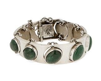 1146
An Antonio Pineda Silver And Green Stone Bracelet
Antonio Pineda (1919-2009)
Circa 1953-1979; Taxco, Mexico
Crown mark for Antonio Pineda; Further stamped: [Eagle 17] / [Eagle 9] / Hecho en Mexico / Silver / 970
Comprising a sterling Modernist bracelet with hourglass silver links alternating with green hardstone cabochon links

6.5" L x 0.75" H
104.1 grams gross
Estimate: $800 - $1,200