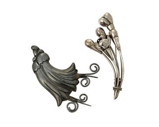 1158
Two Antonio Pineda Silver Floral Brooches
Antonio Pineda (1919-2009)
Circa 1941-1950 and 1953-1979; Taxco, Mexico
One with crown for Antonio Pineda; Variously stamped: AP / Sterling / Mexico / 970 / [Eagle 17]
Comprising two sterling flower brooches, one in oxidized silver with wire tendrils (2.5" H x 3.5" W) and one with a spray of buds and blooms (1.5" H x 3.625" W), 2 pieces

52.4 grams
Estimate: $500 - $700