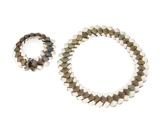1170
A Set Of Hector Aguilar Silver And Copper Jewelry
Hector Aguilar (1905-1986)
Circa 1948-1962; Taxco, Mexico
Each stamped: HA / .940 / Taxco / [Eagle 9]
Comprised of a collar link necklace and matching bracelet, each formed of silver and copper chevron links, each with a hook clasp, 2 pieces

Necklace: 16.5 " L x 1" H; Bracelet: 7" L x 1" H
197.4 grams gross
Estimate: $800 - $1,200