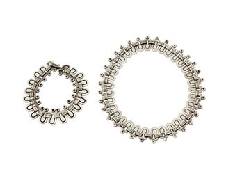 1171
A Set Of Hector Aguilar Silver Jewelry
Hector Aguilar (1905-1986)
Circa 1940-1945; Taxco, Mexico
Bracelet stamped: HA / Taxco / 940
Comprised of a collar necklace and matching bracelet of geometric links, each with hook closure, which may be linked to form a longer necklace, 2 pieces

Necklace: 15.25" L x 0.75" H; Bracelet: 8.25" L x 0.75" H
139.8 grams
Estimate: $800 - $1,200