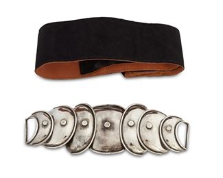1173
A Hector Aguilar "Armadillo" Sterling Silver Belt Buckle
Hector Aguilar (1905-1986)
Circa 1943-1948; Taxco, Mexico
Stamped: HA / Sterling / Made in Mexico
A two-piece clasp belt buckle of graduated hammered silver concave discs with rivet accents and ridged edges, together with a removable soft black leather belt, 3 pieces

Buckle: 2.75" H x 7.75" W
128.4 grams
Estimate: $600 - $800