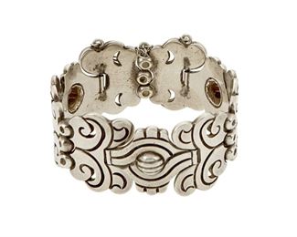 1178
A Hector Aguilar Sterling Silver Bracelet
Hector Aguilar (1905-1986)
Circa 1948-1955; Taxco, Mexico
Stamped: HA / Taxco / .940 / [Eagle 3, older style]
A silver link bracelet with incised curvilinear links and silver bar spacers with pin closure

6.75" L x 1.125" H
87.7 grams
Estimate: $700 - $900