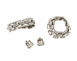 1183
A Group Of Hector Aguilar Silver Jewelry
Hector Aguilar (1905-1986)
Circa 1940-1945; Taxco, Mexico
Each stamped: HA; Variously stamped: Sterling / Made in Mexico / TB [conjoined]
Comprised of two chunky rippled-edged square-link bracelets and a pair of matching earrings, 4 pieces

Each bracelet: 7.25" L x 1" H; Each earring: 0.875" H
216 grams
Estimate: $700 - $900