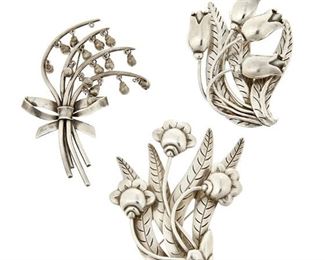 1184
A Group Of Hector Aguilar Sterling Silver Floral Brooches
Hector Aguilar (1905-1986)
Circa 1940-1945 and 1948-1962; Taxco, Mexico
Each stamped: HA / Taxco; Variously stamped: 940 / 990 / .940 / Mexico / [Eagle 9] / Taller Borda
Comprised of three sterling floral bouquet brooches, including one with lily of the valley bell flowers, 3 pieces

Largest: 3.75" H x 3.5" W
118.7 grams
Estimate: $400 - $600