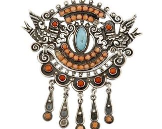 1189
A Matl Silver Pendant/Brooch
Matilde Poulat (c. 1900-d. 1960)
Circa 1934-1955; Mexico City, Mexico
Stamped to round plaque: Matl / 0.925 / Hecho en Mexico
Designed by Matilde Poulat, the elaborate dove-motif articulated sterling silver brooch with central set turquoise, set coral and coral fringe

3.125" H x 2.875" W
29.8 grams gross
Estimate: $700 - $900
