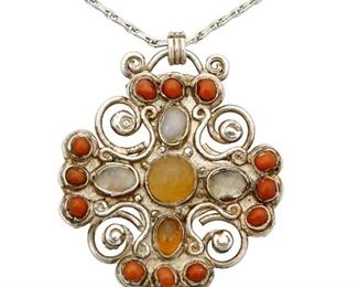 1190
A Matl Silver, Coral And Opal Pendant
Matilde Poulat (c. 1900-d. 1960)
Circa 1934-1940; Mexico City, Mexico
Pendant stamped: Matl; Chain stamped: 925
Designed by Matilde Poulat, a quatrefoil pendant with filigree wire overlay and set coral and opals, on a silver chain

Pendant: 1.875" H x 1.5" W; Chain: 19" L
19.5 grams gross
Estimate: $800 - $1,200