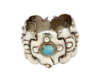 1192
A Matl Silver Link Bracelet With Turquoise
Matilde Poulat (c. 1900-d. 1960)
Circa 1934- 1948; Mexico City, Mexico
Stamped to plaque: Matl
Designed by Matilde Poulat, a bracelet with repousse links and set turquoise to central panel

7" L x 1.75" H
67.8 grams gross
Estimate: $800 - $1,200
