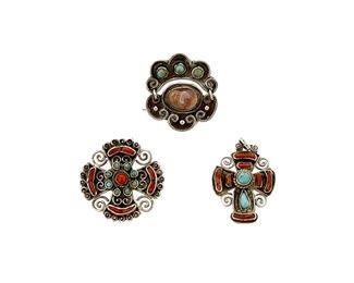1194
A Trio Of Matl Silver And Hardstone Jewelry
Matilde Poulat (c. 1900-d. 1960)
Circa 1934-1940 and 1934-1948; Taxco, Mexico
Each variously stamped: Matl
Designed by Matilde Poulat, comprising an articulated brooch with an opal cabochon and set turquoise (1.25" H), a silver quatrefoil brooch with set coral and turquoise, (1.25" Dia.), and a silver cruciform pendant with set coral and turquoise (1.25" H), 3 pieces

21.5 grams gross
Estimate: $500 - $700