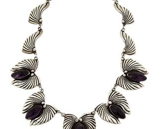 1199
A Los Castillo Sterling Silver And Amethyst Necklace
Circa 1950-1965; Taxco, Mexico
Stamped: Los Castillo / Taxco / Sterling / Made in Mexico / [Eagle 15]
A silver link necklace with five central stylized moth panels, each set with a large oval cabochon amethyst stone in dark purple
17.5" L x 1.25" H
76.9 grams gross
Estimate: $800 - $1,200