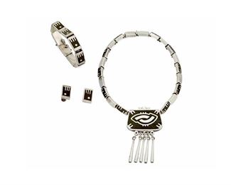 1207
A Mixed Set Of Los Castillo "Onix Negro" Jewelry
Circa 1959-1965; Taxco, Mexico
Each stamped for Los Castillo; Variously stamped: Onix Negro / Hecho en Mexico / [Eagle 15] / Sterling / Made in Mexico / 30 / 43
Comprising a necklace of inlaid stone and silver links suspending an inlaid stone and silver pendant with silver dangles, as well as a link bracelet of similar design with clasp closure and chain guard and a pair of screw back earrings, 4 pieces
Necklace: 15.25" L x 3" H; Bracelet: 8" L x 0.5" H; Each earring: 0.75" H
146.6 grams gross
Estimate: $400 - $600