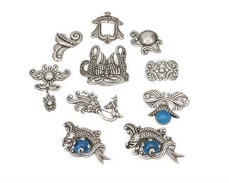 1210
A Large Group Of Los Castillo Silver Brooches
Circa 1940-1945 and 1950-1965; Taxco, Mexico
Nine stamped: Los Castillo / Taxco / Sterling / Made in Mexico / [Design number]; One further stamped: [Eagle 15]
Comprising ten incised sterling brooches in various designs including two elaborate brooches of a diving fish, each set with a blue glass cabochon (No. 514), a bow brooch with suspended blue cabochon (No. 692), a brooch/pendant of a pair of swans (No. 516) and five brooches in various botanical designs (Nos. 220, 466, 543P, 548, 595), as well as a hand-hammered foliate dress pin, 10 pieces
Largest: 1.75" H x 3.5" W
239.1 grams gross
Estimate: $500 - $700