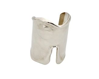 1220
A Mexican Sterling Silver Cuff Bracelet
Late 20th/21st century; Mexico
Stamped: MFR / 925 / TF-07
A freeform silver modernist cuff with repousse dimple accent and raised edges
6.5" total inner C x 3.75 H, including a 1.5" gap
142.5 grams
Estimate: $200 - $300