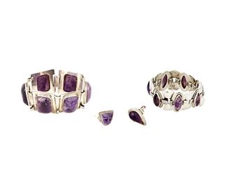 1228
A Group Of Abraham Paz Sterling Silver And Amethyst Jewelry
Abraham Paz (b. 20th century)
Mid-20th century; Mexico City, Mexico
Each stamped: AP / Sterling / Mexico; Variously stamped: [Eagle 1 ?] / [Eagle 22]
Comprising two bracelets, one with rectangular silver links set with amethyst cushion cabochons (7" L x 1.125" H) and one with alternating silver shield and amethyst set diamond links (6.5" L x 1.125" H), as well two rings, including one with a teardrop set amethyst (Ring size: 6.5) and one set with a carved amethyst mask (Ring size: 5.5), 4 pieces

140.9 grams gross
Estimate: $600 - $800