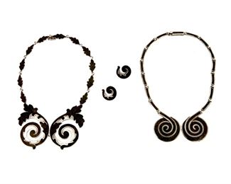 1237
A Group Of Margot De Taxco Silver And Enamel Jewelry
Margot Van Voorhies (1896-1985)
Circa 1955-1978; Taxco, Mexico
Each stamped: Margot de Taxco / Sterling / Made in Mexico / [Eagle 16] / [Design number]
Comprising a "Floral Spiral" bib necklace (16" L x 1.75" H) in black with similar earclips (Each: 0.875" H), each No. 5384 and a "Circular Spiral" bib necklace in black, No. 5357 (15" L x 1.75" H), 4 pieces

132.3 grams gross
Estimate: $700 - $900