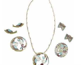 1239
An Assembled Suite Of Margot De Taxco Silver And Enamel Jewelry
Margot Van Voorhies (1896-1985)
Circa 1955-1978; Taxco, Mexico
Each stamped: Margot de Taxco / Sterling / Made in Mexico / [Eagle 16] / [Design number]
A group of white, purple, teal and green enamel jewelry including a "Quetzal Bird" necklace with detachable pendant/brooch and an additional brooch and pair of earclips, each No. 5755, as well as an oval "Flowers in a Circle" brooch/pendant No. 5860, and an additional pair of butterfly earclips, No. 5861, 7 pieces

Necklace: 21.5" L x 2" H; Largest brooch: 2" H; Largest earclip: 1.5" H
118.5 grams gross
Estimate: $700 - $900