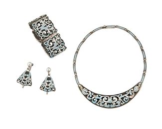 1241
A Suite Of Margot De Taxco "Classic Scrolls" Jewelry
Margot Van Voorhies (1896-1985)
Circa 1955-1978; Taxco, Mexico
Each stamped: Margot de Taxco / Sterling / Made in Mexico / [Eagle 16, indistinct] / 5583
Comprising a blue and white enamel "Classic Scrolls" bib necklace, together with a matching link bracelet and a pair of earrings, 4 pieces

Necklace: 15" L x 0.75" H; Bracelet: 6.25" L x 1.25" H; Each earring: 1.75" H
159.0 grams gross
Estimate: $400 - $600