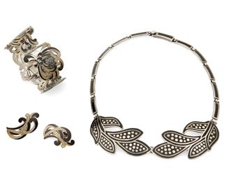 1243
A Mixed Group Of Margot De Taxco Silver And Enamel Jewelry
Margot Van Voorhies (1896-1985)
Circa 1955-1978; Taxco, Mexico
Each stamped: Margot de Taxco / Sterling / Made in Mexico / [Eagle 16] / [Design number]
Comprising a brown and black enamel floral "Chrysanthemum" link bracelet with matching earclips, each No. 5685, as well as a black and silver foliate bib necklace No. 5719, 4 pieces

Necklace: 17" L x 1.375" H; Bracelet: 6.75" L x 1.25" H; Each earring: 1.375" H
148.5 grams gross
Estimate: $800 - $1,200