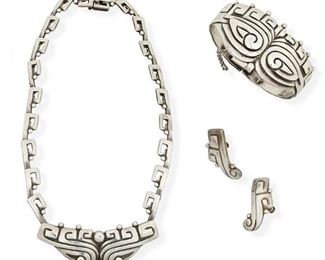 1253
A Group Of Margot De Taxco Sterling Silver Jewelry
Margot Van Voorhies (1896-1985)
Circa 1948-1978; Taxco, Mexico
Each stamped: Margot de Taxco / [Eagle 16] / Made in Mexico / Sterling / 5243
Comprising a silver link necklace with matching link clasp bracelet and pair of earclips, No. 5243, 4 pieces

Necklace: 16" L x 0.875" H; Bracelet: 7" L x 1.25" H; Each earring: 1.375" H
120.8 grams
Estimate: $800 - $1,200