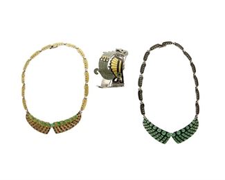 1254
A Group Of Margot De Taxco Silver And Enamel Jewelry
Margot Van Voorhies (1896-1985)
Circa 1955-1978; Taxco, Mexico
Each stamped: Margot de Taxco / Sterling / Made in Mexico / [Eagle 16] / [Design number]; Bracelet further stamped: 925
Comprised of two bib link necklaces, one in yellow and green enamel, the other in green and black enamel, each in a "Jeweled Circles and Squares" design No. 5603, as well as a hinged plaque link bracelet in green, black and yellow enamel in a "Quetzal Feathers " design No. 5695, 3 pieces

Each necklace: 16" L x 0.75" H; Bracelet: 7" L x 1.75" H
183.5 grams gross
Estimate: $800 - $1,200