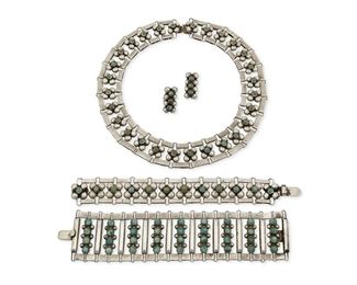 1256
A Group Of Fred Davis Silver And Turquoise Jewelry
Fred Davis (1880-1961)
Pre-1948; Mexico City, Mexico
Stamped for Fred Davis; Further stamped: Mexico / Silver / Made in Mexico; Earrings attributed to Davis
A necklace comprised of silver half sphere clusters each centering a cabochon turquoise (16" L x 1" H), together with two matching bracelets (7.5" L and 7.75" L) and a pair of screw-back earrings (Each: 1" H) , 5 pieces

252 grams gross
Estimate: $1,500 - $2,500