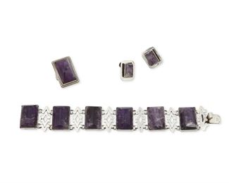 1257
A Group Of Fred Davis Silver And Amethyst Jewelry
Fred Davis (1880-1961)
Pre-1948; Mexico City, Mexico
Stamped for Fred Davis; Further stamped: Made in Mexico / Mexico / Silver
Comprising a rectangular carved amethyst link bracelet with ring and a pair of screw back earrings, 4 pieces

Bracelet: 7.25" L x 1" H; Each earring: 0.75" H; Ring size: 6"; 1.125" H
98.1 grams gross
Estimate: $600 - $800