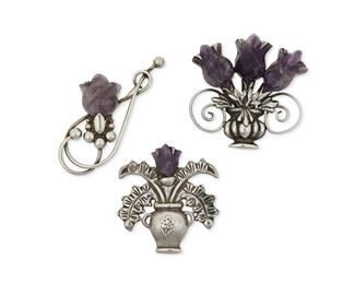 1259
A Group Of Fred Davis Silver And Amethyst Brooches
Fred Davis (1880-1961)
Pre-1948; Mexico City, Mexico
Each stamped for Fred Davis: Further stamped: Silver / Mexico
A group of stylized flower brooches with carved amethyst flowers, 3 pieces

Largest: 3.325" H x 1.5" W
101 grams gross
Estimate: $800 - $1,200