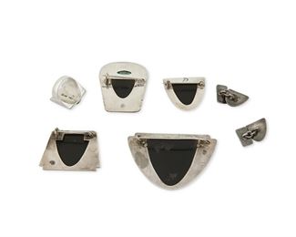 1262
A Group Of Fred Davis Silver And Obsidian Jewelry
Fred Davis (1880-1961)
Pre-1948; Mexico City, Mexico
Stamped for Fred Davis; Ring further stamped: Silver
Comprised of three carved obsidian mask brooches (Largest: 2" H x 2.75" W), a carved obsidian and set turquoise brooch (2" H x 1.5" W), a carved obsidian ring (Ring size: 7.25), and a similar pair of cufflinks (Each: 0.625" H), 7 pieces

92.0 grams gross
Estimate: $600 - $800