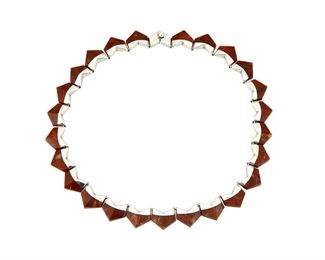 1268
An Enrique Ledesma Silver And Hardstone Necklace
Enrique Ledesma (d. 1979)
Circa 1955-1979; Taxco, Mexico
Stamped: Ledesma / Taxco / Mexico / 925 / FS / [Eagle 3] / 205
Comprising a delicate necklace designed with silver and russet Jasper hardstone chevron links

16" L x 0.5" H
50.8 grams gross
Estimate: $300 - $500