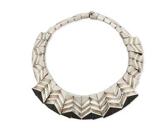 1272
A Mexican Silver And Onyx Necklace
Late 20th century; Mexico
Stamped: Monteros / TM-100 / T / M-970 / Mexico
A sterling collar necklace with graduated chevron trapezoidal links, the center links set with triangular onyx to the ends
14" L x 1.25" H
215.4 grams gross
Estimate: $400 - $600