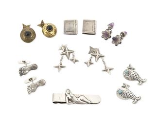 1273
A Mixed Group Of Hubert Harmon Cuff Links And Money Clip
Hubert Harmon (1913-2004)
Circa 1942-1944 and 1942-1948; Taxco and Mexico City, Mexico
Each stamped for Hubert Harmon; Variously stamped: Sterling / Made in Mexico / Hubertus / Taxco / Mexico / [winged feet]
Comprising six sets of cuff links in various designs including set amethyst cones, dangling stars, a set of bare feet, a pair of silver fish set with turquoise eyes, a pair of books with hinged covers, and a pair of onyx-set brass discs, together with a money clip with an applied silver reclining nude figure, 13 pieces

Largest cuff links: 1.5" H; Clip: 1" H x 2.625" W
101.3 grams gross
Estimate: $600 - $800