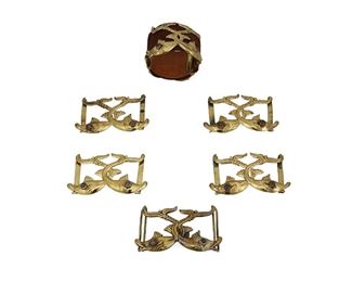 1275
A Hubert Harmon Fish Bracelet And Belt Conchos
Hubert Harmon (1913-2004)
Circa 1942-1948; Mexico City, Mexico
Each buckle variously stamped: Hubert Harmon / Mexico / [winged feet cipher]
Designed with conjoined repousse brass fish with set amethyst eyes and comprising a leather bracelet with two fish conchos and brass buckle, as well as a brass fish two-piece buckle accompanied by four matching fish conchos, 7 pieces

Bracelet: 6.75" L x 1.875" H; Each concho: 2" H x 3.5" W; Buckle: 2" H x 3.5" W
Estimate: $200 - $400